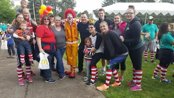 Mr. Rooter Plumbing employees Dillon Anderson, Evan Gilges and Brian Lee, standing for a picture with Ronald McDonald.