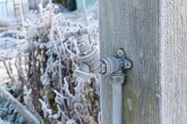 Close-up photo of an outdoor water tap covered in frost. | Mr. Rooter Plumbing of South Jersey