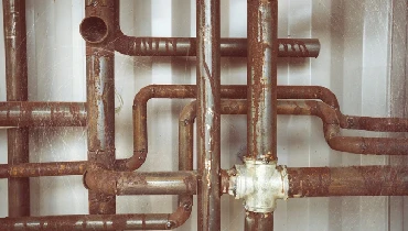 A system of rusted plumbing pipes.